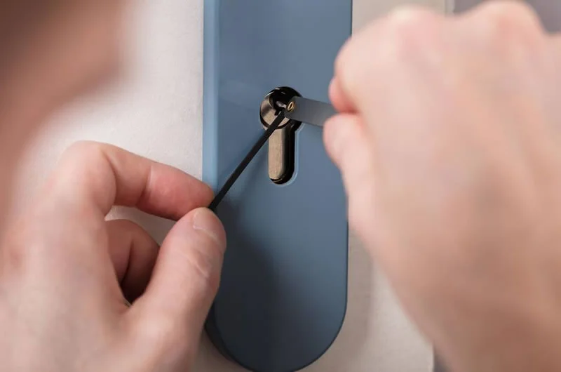 Locksmith picking a door lock